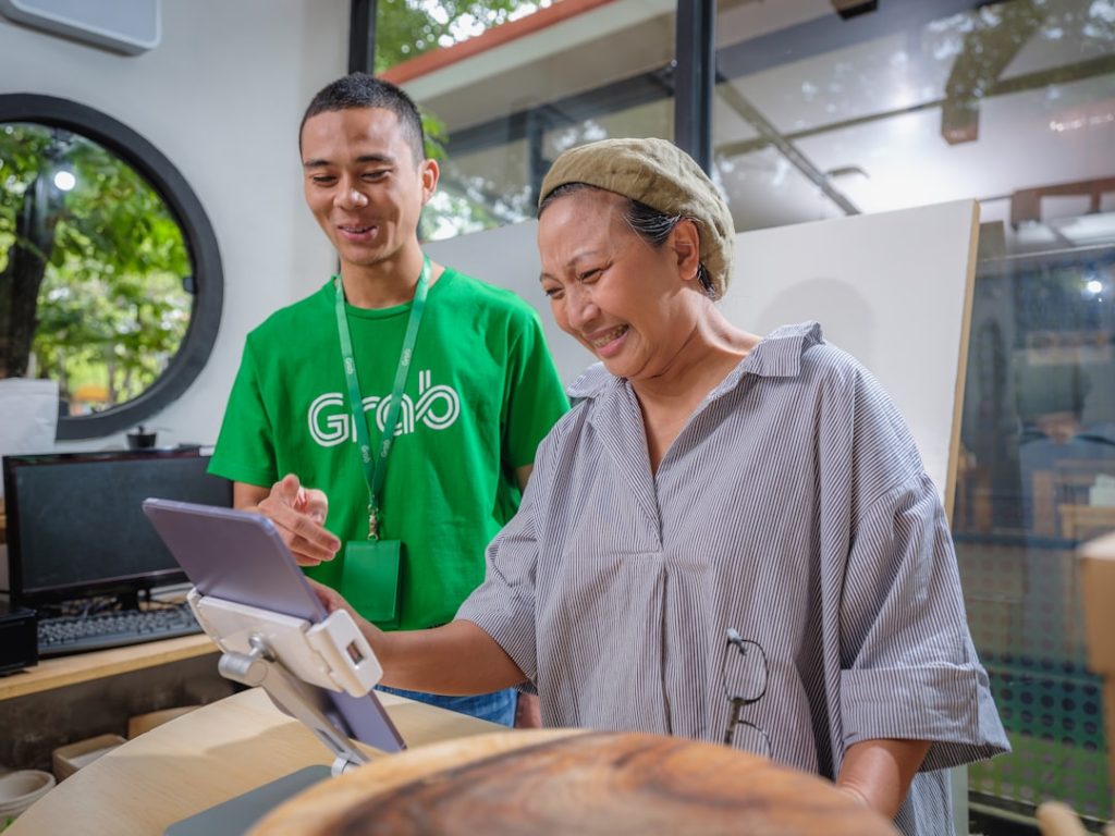 a-man-and-a-woman-looking-at-a-tablet-19gh-tl252o